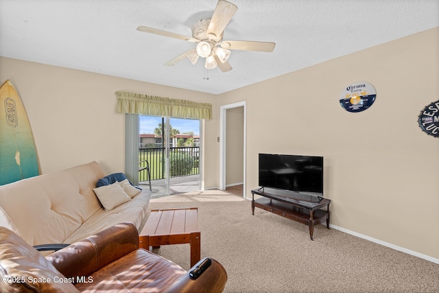 living room with ceiling fan and carpet