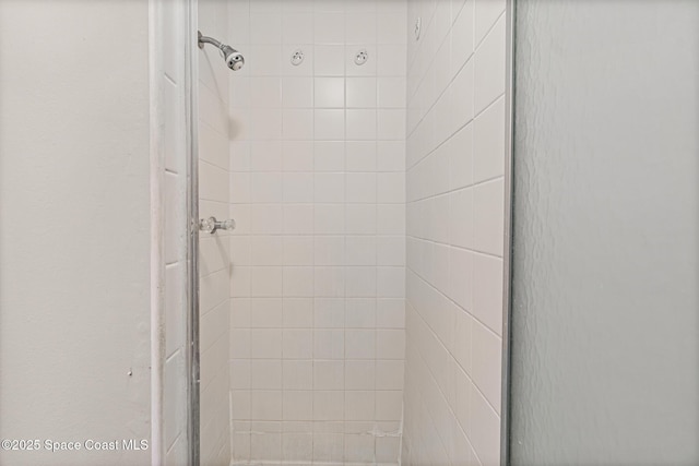 bathroom with a shower with door