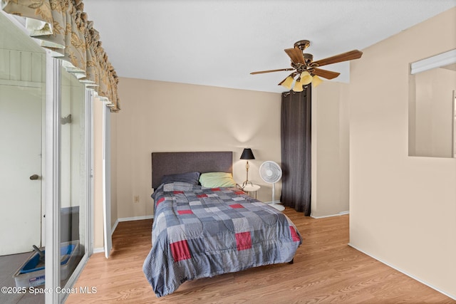 bedroom with ceiling fan and light wood-type flooring