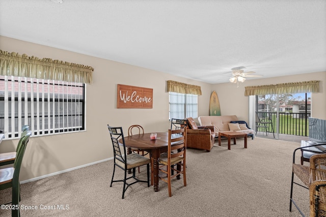 dining space with carpet and ceiling fan