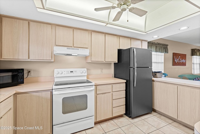 kitchen with light tile patterned flooring, white range with electric stovetop, stainless steel fridge, and light brown cabinets