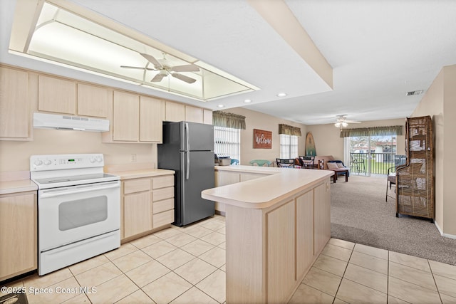 kitchen with kitchen peninsula, white electric range oven, light brown cabinets, light carpet, and stainless steel fridge