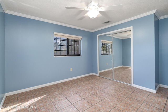 unfurnished bedroom with ceiling fan, a closet, crown molding, and a textured ceiling