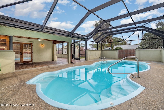 view of pool featuring a lanai, french doors, a patio, and ceiling fan