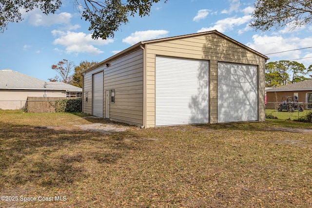 garage featuring a lawn