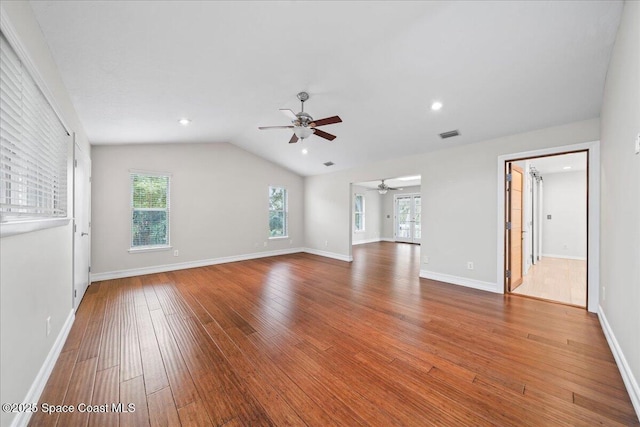 interior space featuring ceiling fan, plenty of natural light, vaulted ceiling, and hardwood / wood-style flooring