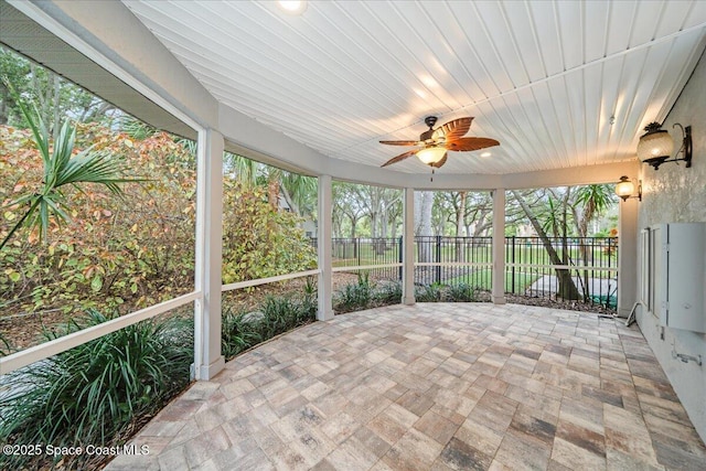 sunroom featuring ceiling fan