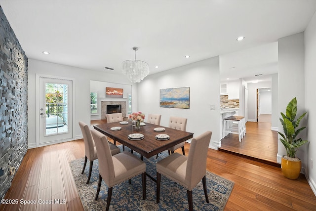 dining space with a notable chandelier and light wood-type flooring