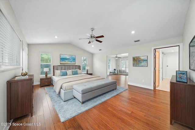 bedroom with hardwood / wood-style floors, vaulted ceiling, and ceiling fan