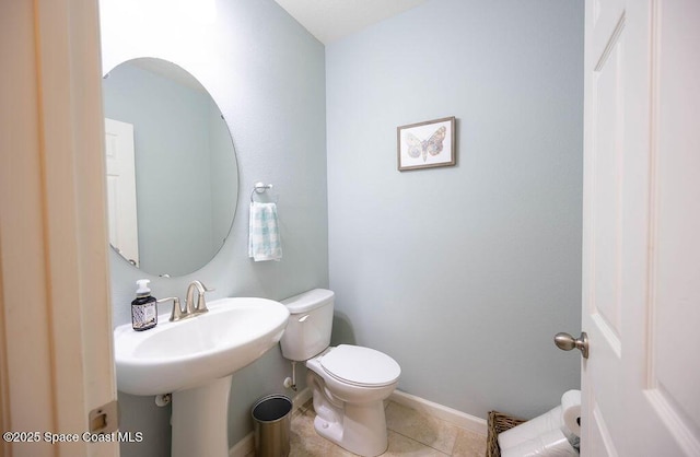 bathroom featuring toilet and tile patterned flooring