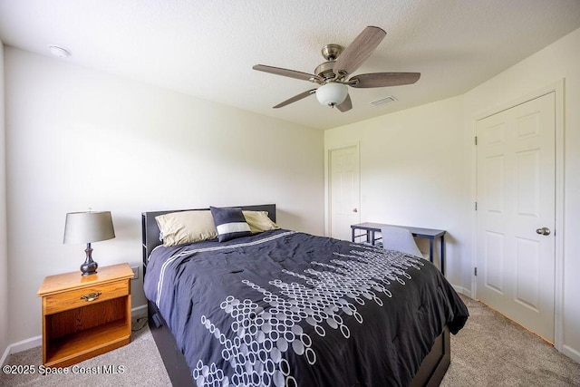 bedroom featuring ceiling fan and light carpet