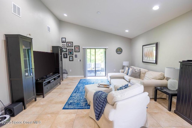 living room featuring high vaulted ceiling and light tile patterned floors