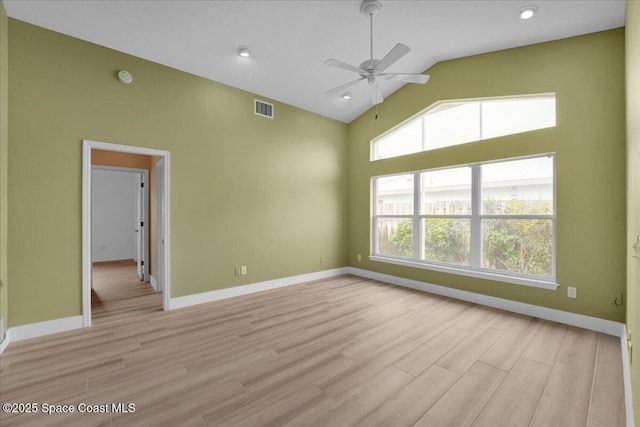 spare room with light wood-type flooring, ceiling fan, and lofted ceiling