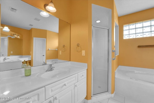 bathroom with vanity, tile patterned flooring, independent shower and bath, and a textured ceiling