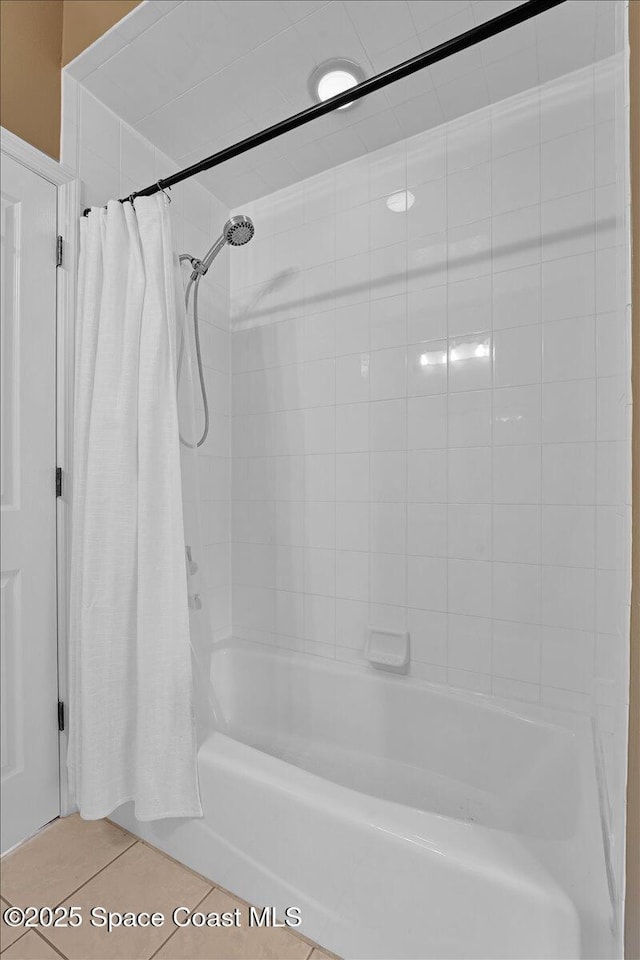 bathroom with shower / bath combo and tile patterned floors