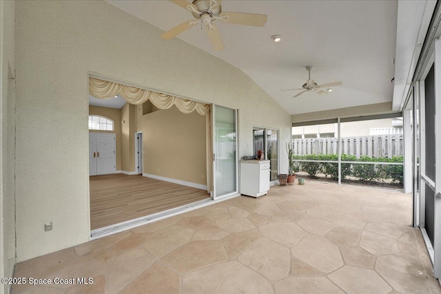 unfurnished sunroom featuring ceiling fan and lofted ceiling