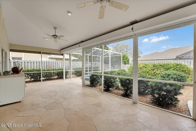 unfurnished sunroom with ceiling fan and a healthy amount of sunlight