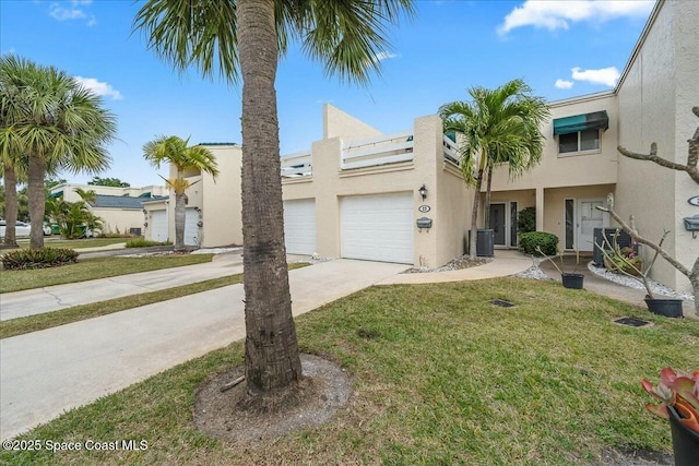 view of front of property with central AC unit, a front lawn, and a garage