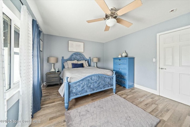 bedroom with wood-type flooring and ceiling fan