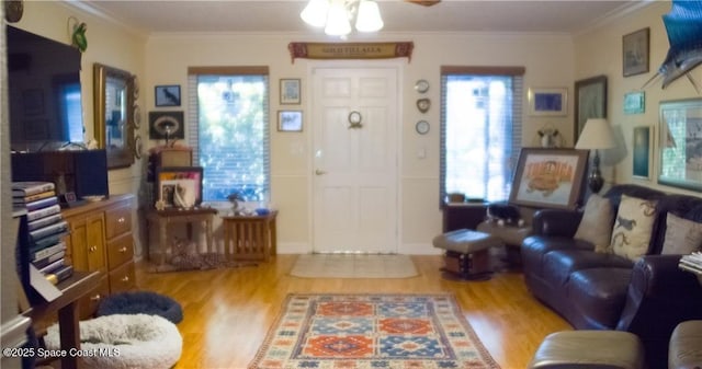 living room featuring crown molding, ceiling fan, and wood-type flooring