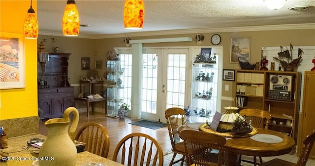 dining room featuring french doors, plenty of natural light, and ornamental molding