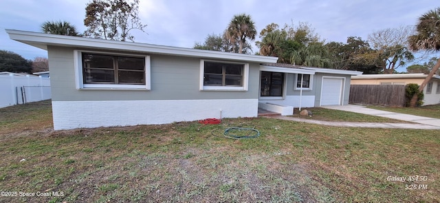 single story home featuring a garage and a front yard