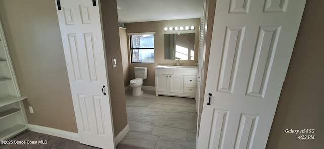 bathroom featuring toilet and vanity