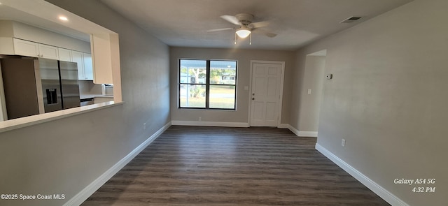 interior space with ceiling fan and dark wood-type flooring