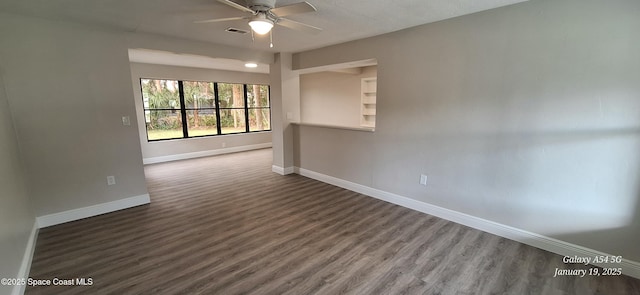 spare room featuring ceiling fan and dark hardwood / wood-style flooring