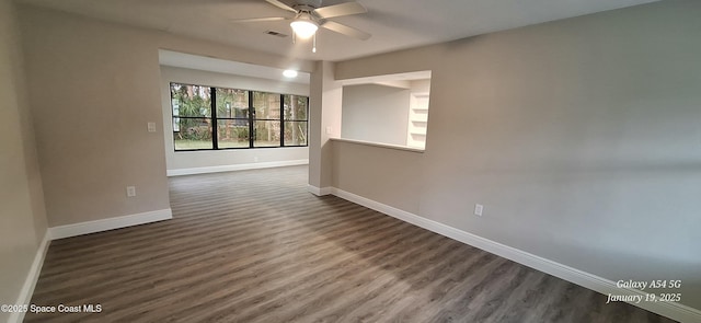 unfurnished room with ceiling fan and dark hardwood / wood-style flooring