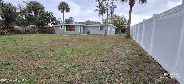 rear view of property featuring a yard