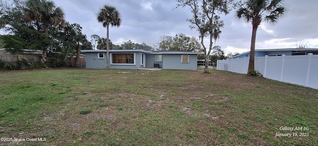 rear view of house with a yard