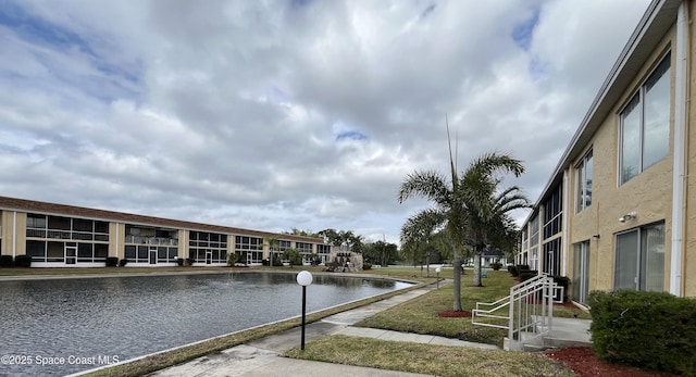 exterior space with a yard and a water view