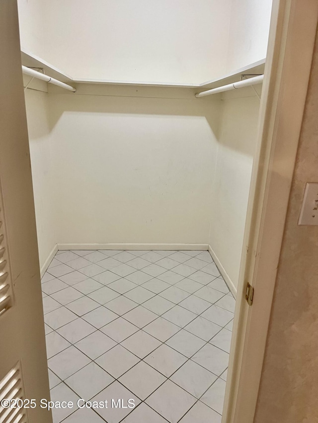 walk in closet featuring light tile patterned flooring