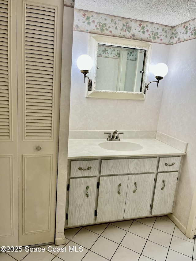 bathroom with vanity, tile patterned floors, and a textured ceiling