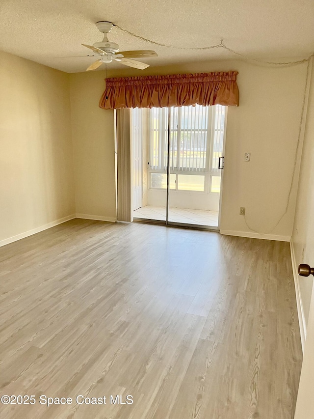 unfurnished room featuring a textured ceiling, ceiling fan, and wood-type flooring