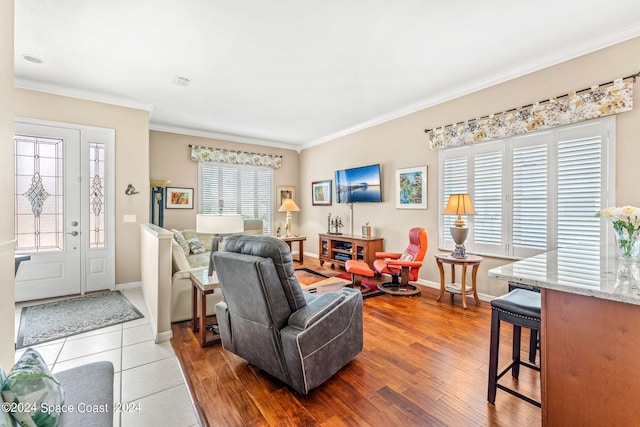 living room with hardwood / wood-style floors and crown molding