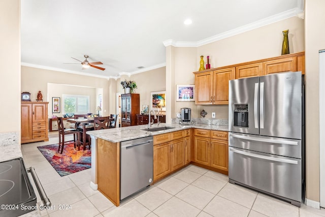 kitchen with sink, ornamental molding, light stone counters, kitchen peninsula, and stainless steel appliances