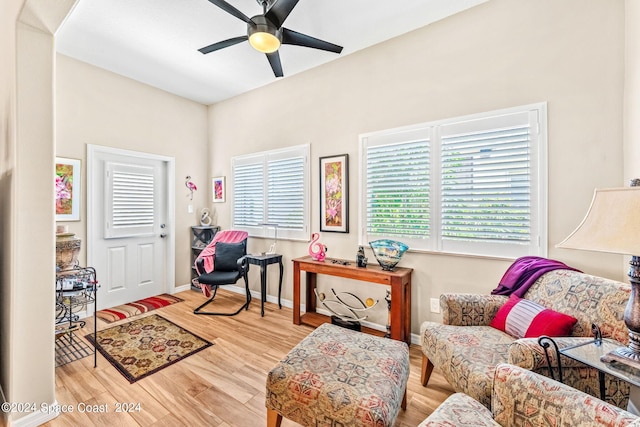 living area featuring light hardwood / wood-style flooring and ceiling fan