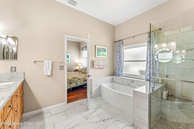 bathroom featuring shower with separate bathtub and vanity