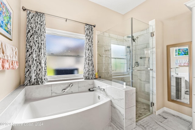 bathroom featuring shower with separate bathtub