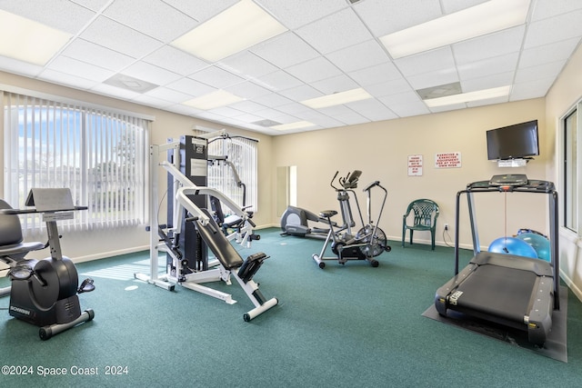 gym with a paneled ceiling