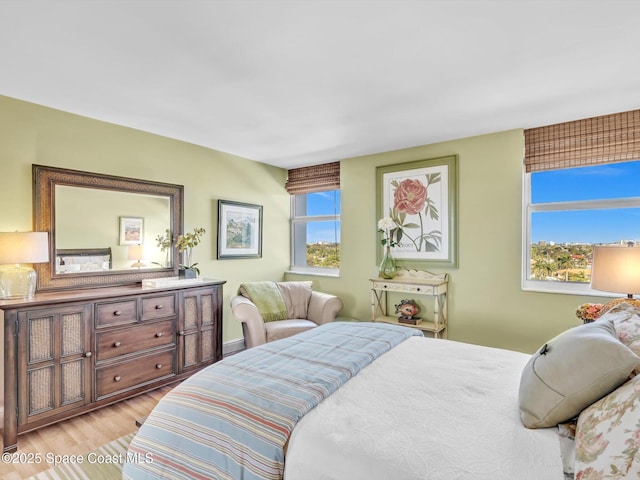 bedroom featuring light wood-type flooring and multiple windows