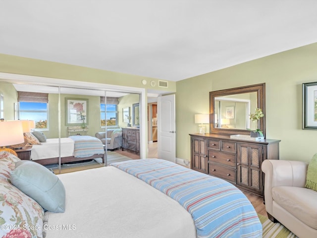 bedroom featuring light hardwood / wood-style flooring and a closet