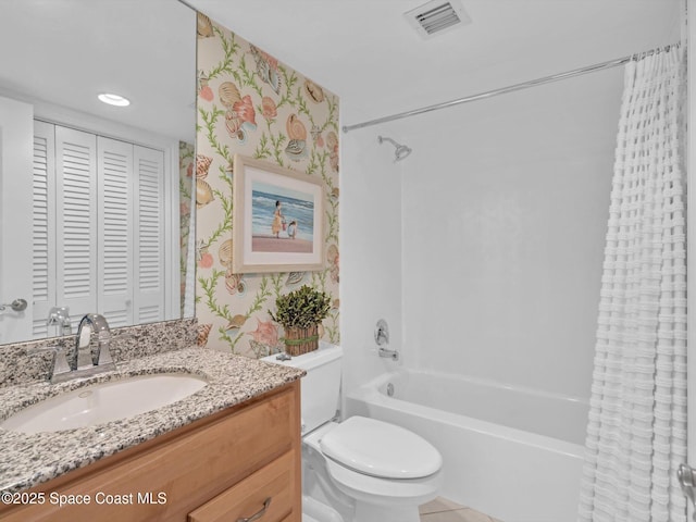 full bathroom with vanity, shower / bath combo, and toilet