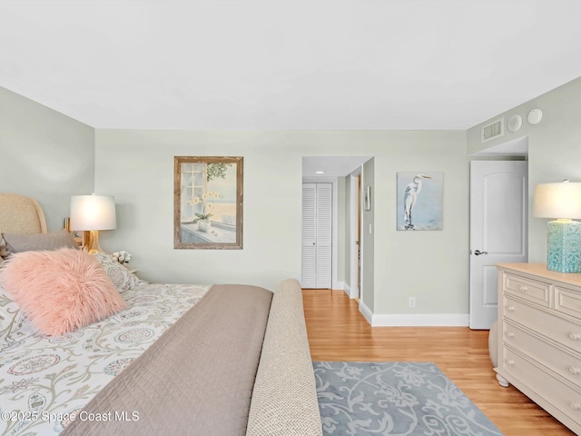 bedroom with a closet and light hardwood / wood-style flooring