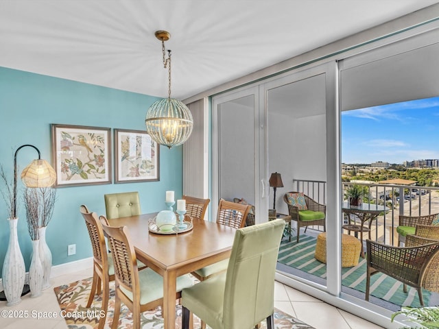 dining space featuring light tile patterned floors and an inviting chandelier