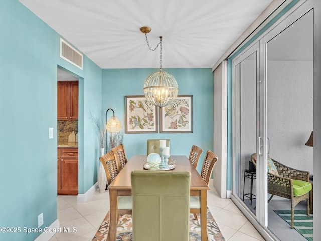 tiled dining area featuring a notable chandelier