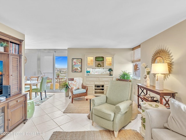 living room featuring expansive windows and light tile patterned floors