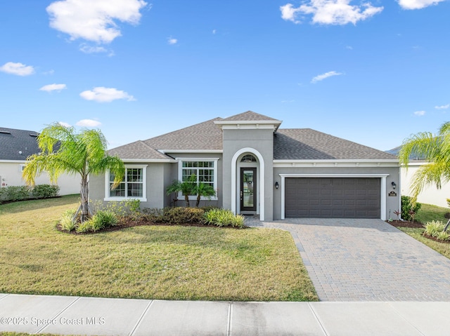 view of front facade with a front yard and a garage